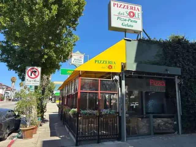 Pizzeria Del Sol yellow awning and street sign