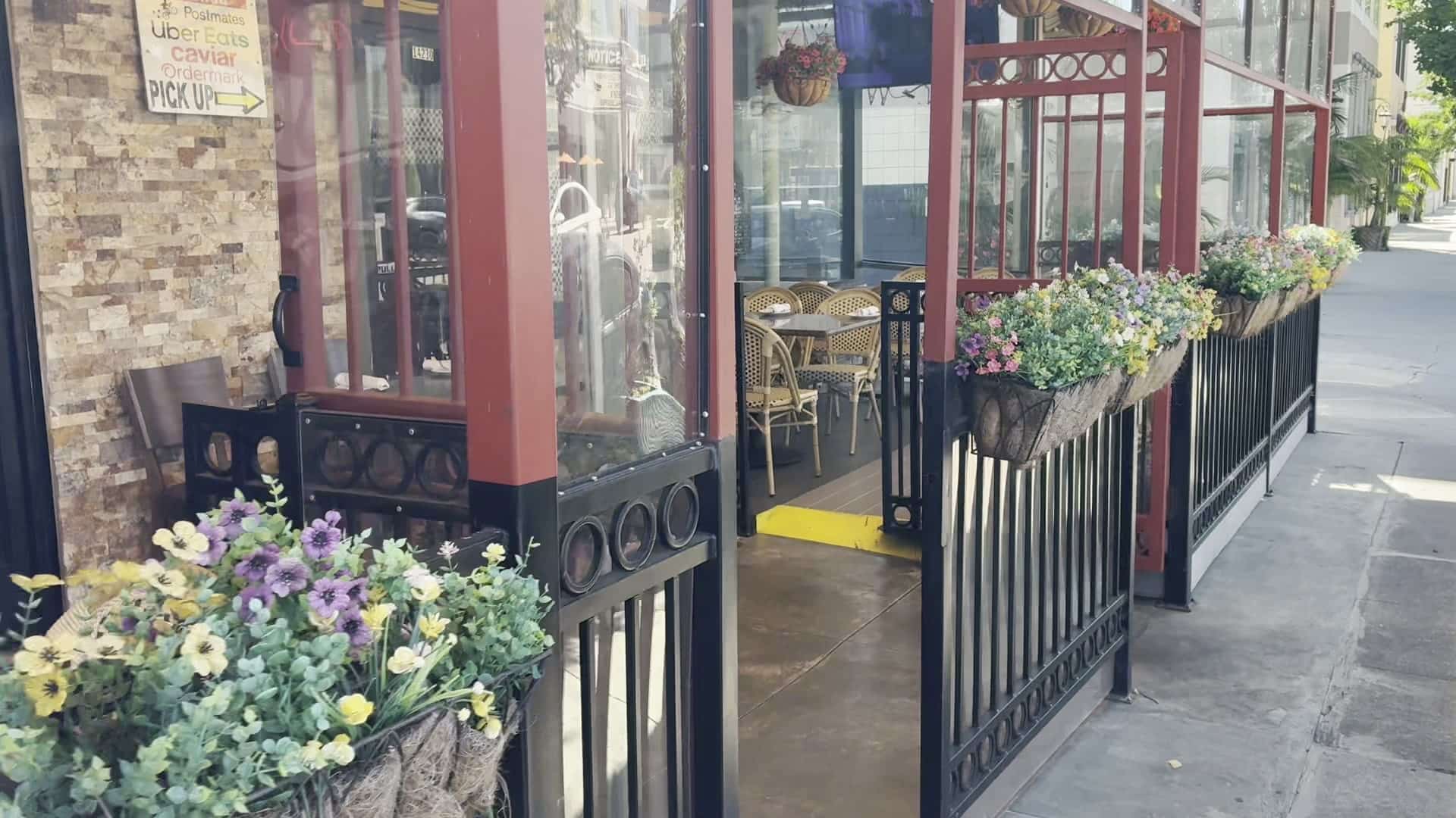 Pizzeria Del Sol front door with planters