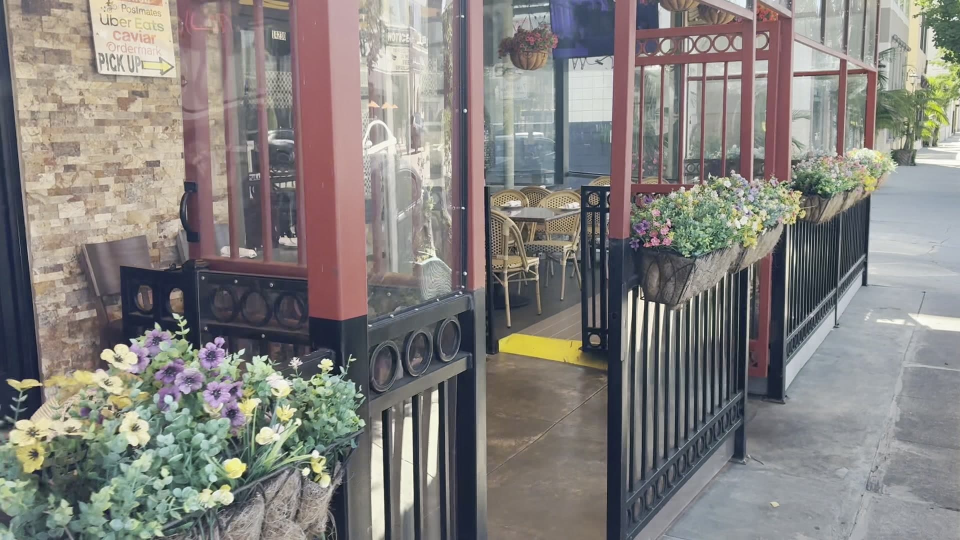 Pizzeria Del Sol front door with planters
